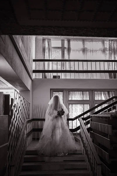 古い不気味な放棄された邸宅で 城の階段に立ってホラーゴースト花嫁のシルエット ホラーハロウィンのコンセプト — ストック写真