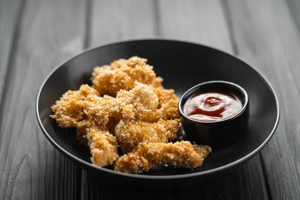 Delicious Crispy Chicken Breast Strips Breadcrumbs Tomato Sauce Plate Black — Stock Photo, Image