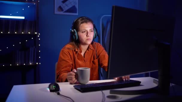 Young Female Gamer Wear Headset Sitting Dark Room Cup Coffee — Stock Video