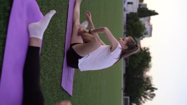 Fit Young Women Stretching Exercise Mat Class Stadium Field Outdoors — Video Stock
