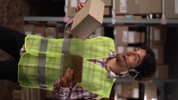 Warehouse Manager Wearing Headset Using Digital Tablet Large Warehouse Vertical — Stock Video