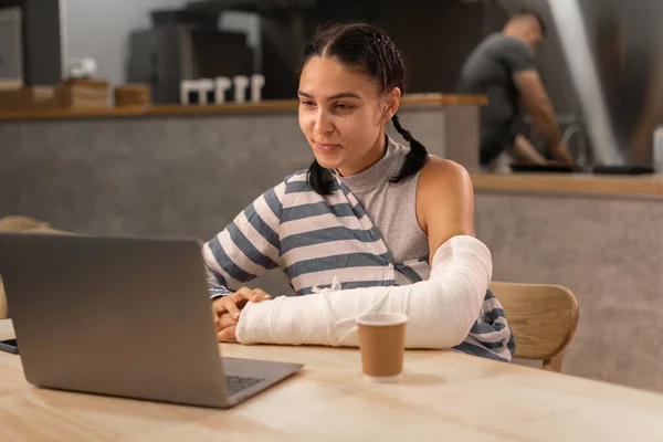 stock image One woman freelancer working online on her laptop computer while sitting at the table at cafe happy smile confident read mail online or video call. Copy space