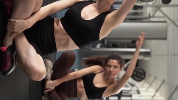 Spor Salonunda Esneme Egzersizleri Yapan Iki Formda Genç Kadın Dikey — Stok video