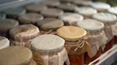 Süpermarkette konserve salatayla tezgah, kadın eli cam bir kavanoz yiyecek alır. Yiyecek alışverişi konsepti. Boşluğu kopyala.