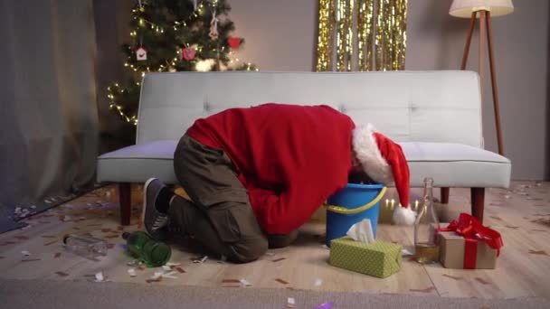サンタのミレニアル世代の人は クリスマスのパーティーの後に吐き気とハングオーバーに苦しんで嫌がります 中毒とアルコール中毒の概念 — ストック動画