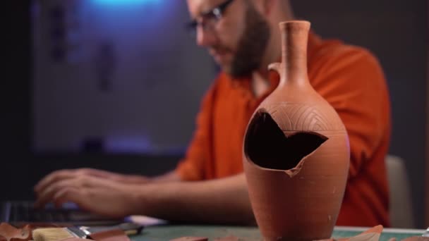 Bald Archeologist Working Late Night Office Studying Old Vase Table — Stock Video