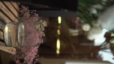 Çiçekçide Gerbera çiçeklerini cam vazoya koyup düzenleyen kadın bir çiçekçi. Dikey video