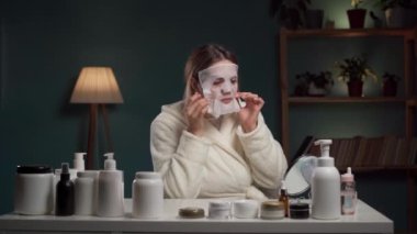 Evdeki spa. Akşam vakti oturma odasında maske takan bir kadın. Boşluğu kopyala