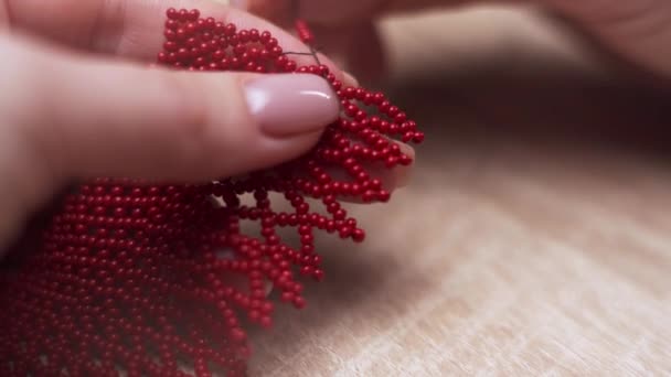 Close Female Hands Weaving Bracelet Red Small Beads While Sitting — Stock Video