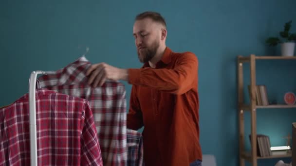 Een Man Die Een Garderobe Schoonmaakt Kleren Een Donatiekist Stopt — Stockvideo