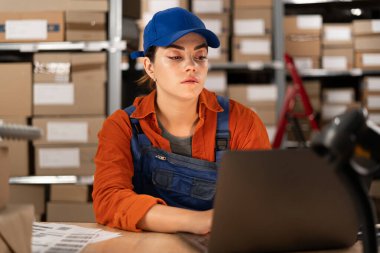 Envanter yöneticisi bilgisayar kullanıyor. Depoda dizüstü bilgisayarda çalışan küçük işletme sahibi. Boşluğu kopyala