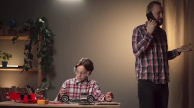 Baba ve oğul akşamları bozuk bir oyuncağı tamir ediyorlar. Bir adam telefonda bir çocuğu görmezden geliyor ve iş yerindeki sorunları çözüyor. Boşluğu kopyala