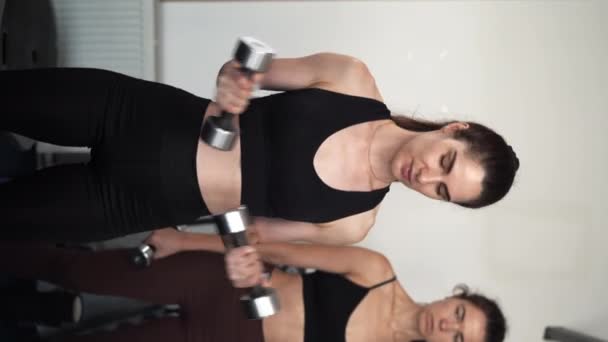 健身者在健身房接受哑铃训练和锻炼社区 运动朋友锻炼肌肉 力量和健康 垂直录像 — 图库视频影像