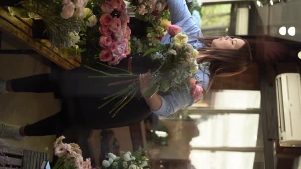 Florista Atencioso Com Buquê Rosas Visto Através Janela Loja Vidro — Vídeo de Stock