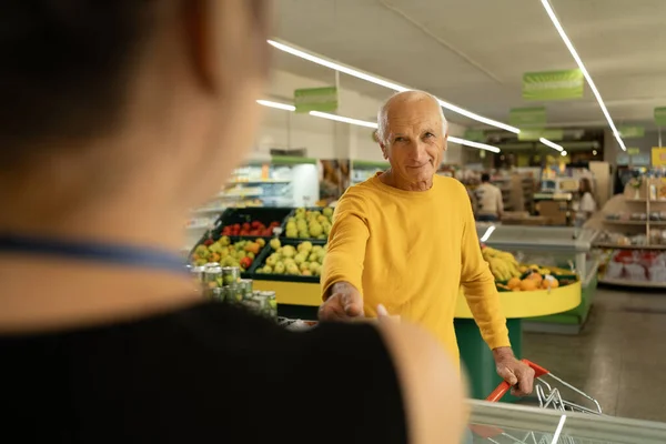 Salesman Helping Old Customer Standing Refrigerator Choose Fresh Meat Grateful Royalty Free Stock Images