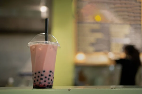 Bubble Tea concept. Plastic glass of bubble tea. Taiwan milk tea with bubbles in cafe