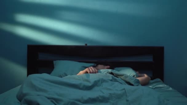 不眠症に苦しむ不安定な落ち込んだ男性と悪夢は 眠りを恐れる彼の頭を抱えているベッドで目覚めます コピースペース — ストック動画