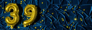 39 numara, altın folyo balon numarası mavi kadife arka planda, konfetiyle birlikte. Doğum günü tebrik kartı, 39. yazı. Yıldönümü etkinliği. Pankart. Şık altın rakamlı, parlak parlak bir ışık. Boşluğu kopyala,