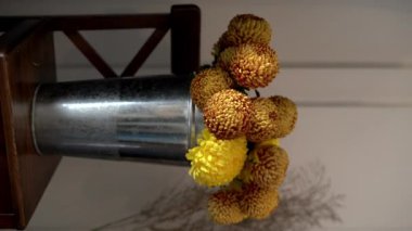Bir buket sonbahar kasımpatısı yapan çiçekçi, çiçekçi dükkanında çalışırken vazodan taze çiçekler alır. Boşluğu kopyala
