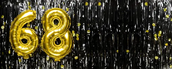 Gold foil balloon number number 68 on a background of black tinsel decoration. Birthday greeting card, inscription sixty-eight. Anniversary event. Banner. copy space.