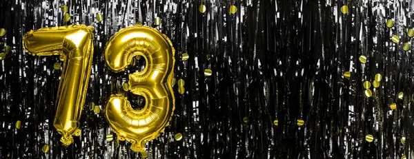 Gold foil balloon number number 73 on a background of black tinsel decoration. Birthday greeting card, inscription seventy-three. Anniversary event. Banner. copy space.