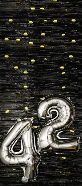 Silver foil balloon number 42 on a background of black tinsel with gold confetti. Birthday card, inscription forty-second. Anniversary event. Vertical banner. copy space.