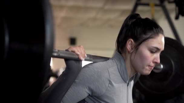 疲惫的汗流浃背的健美女子在健身房练重量级体操 健身女孩用杠铃蹲着 后续行动 — 图库视频影像