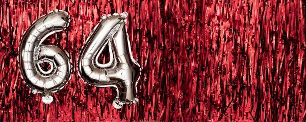 Silver foil balloon number, digit sixty-four on red background. Birthday greeting card with inscription 64. Anniversary celebration event. Banner. Numerical digit. Copy space