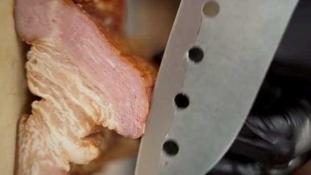 厨师的特写镜头用锋利的中国刀把熏肉切成薄片 培根是鸡蛋和汉堡包最受欢迎的添加剂之一 垂直录像 — 图库视频影像