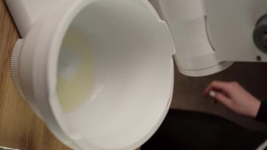 Şef yumurta beyazı için çırpıcı eklentisi tutuyor. Yumurta beyazıyla elektrikli mikser. Dikey video