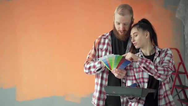 Pasangan Muda Yang Membahas Renovasi Rumah Memilih Warna Cat Dengan — Stok Video