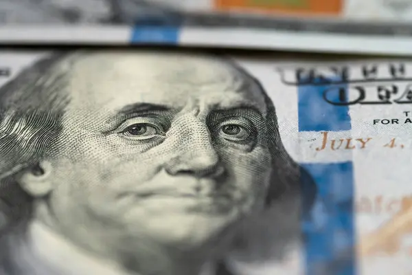 Benjamin Franklin\'s eyes on a hundred dollar bill, macro shot. President portrait us dollar banknote or bill. Close-up