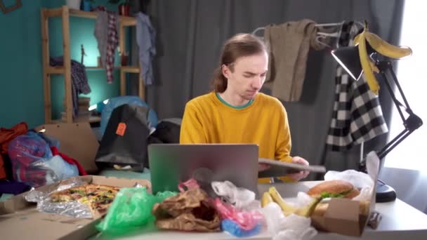 Male Student Studying Messy Room Making Notes Working Garbage His — Stock Video
