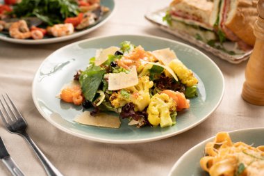 Kızarmış karnabahar, somon ve parmesan peynirli salata bir restoranda masada servis ediliyor. Sağlıklı beslenme kavramı