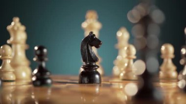 Bir tahtadaki satranç taşlarının yakın plan çekimleri stratejik oyun sergiliyor ve şövalye ve kraliçeye odaklanıyor..