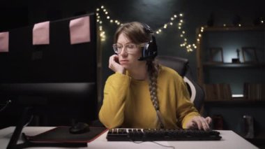 Gözlüklü yetişkin kadın oyuncu kişisel bilgisayarında online video oyununda bir tur oynuyor. Profesyonel oyuncu şampiyonluktan zevk alıyor. İyi bir fikri ve soruna bir çözümü var.