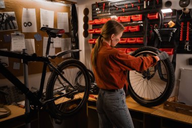 Küçük bir tamirci ya da mühendis işi. Küçük işletme sahibi kadın motor bakım hizmeti veriyor. Garajda ya da araç atölyesinde çalışan teftiş aracı. Boşluğu kopyala