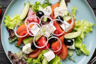 Mavi tabakta taze Yunan salatası, düz uzanma, üst manzara, yakın çekim