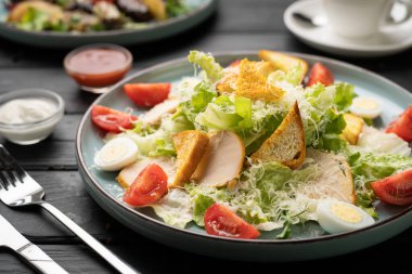 Izgara tavuk göğlü taze Sezar salatası, çıtır kıtır ekmek, yarım kiraz domatesleri, haşlanmış yumurta, romaine marulu, rendelenmiş peynir ve otlar. Sağlıklı dengeli beslenme kavramı.