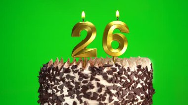 Çikolatalı doğum günü pastasında mum yakmak yeşil krom anahtar arka planda, 26 numaralı altın mumla. 26 yıldır doğum günü pastasını kutluyoruz. Boşluğu kopyala