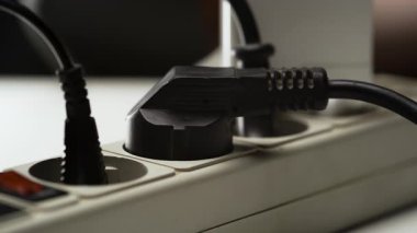 Erkek eli, birden fazla prizden elektrik prizini kapatır. Elektrik teçhizatı ve elektrik enerjisi. Yakın plan.