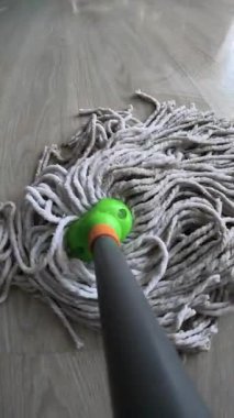 Paspas temizleme yeri, POV. Temizlikçi kaplamaları paspaslıyor. Yerleri süpürüyor. Boşluğu kopyala