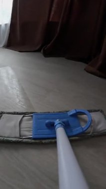 Dairesinde paspas temizleyicisi ya da temizlikçisi var. Temizlik ekipmanları. Bakış açısı. Yakın plan. Dikey video