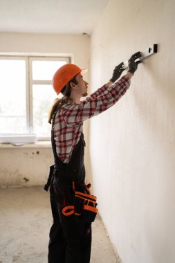 Koruyucu kask takan inşaatçı, ruhsal düzeyde tadilat ya da inşaat işi yapıyor. Boşluğu kopyala