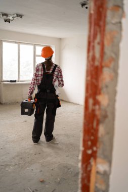 Profesyonel tamircinin ya da tamircinin elinde alet çantasıyla evde dikilmesinin arkası. Boşluğu kopyala