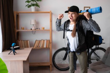 Sırt çantasıyla gezmeye hazır gezgin kadın kazanan el kaldırıyor. Yaşam tarzı Seyahat. Boşluğu kopyala