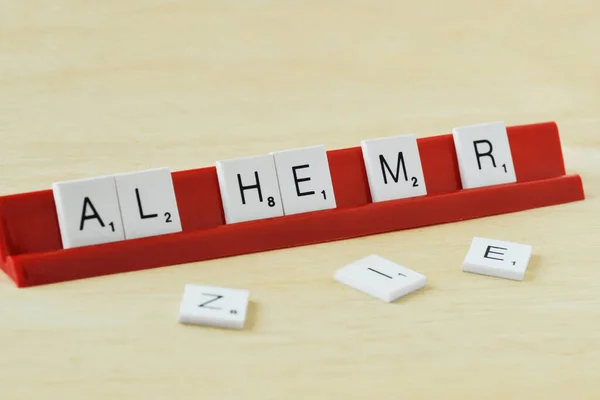 The word Alzheimer written with scrabble game letters - Concept of fading memories