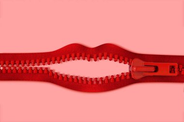 Mouth made of red zipper on pink background - Concept of violence against women and communication issues clipart