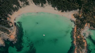 Picturesque drone point of view Cala Agulla is a beautiful beach in Majorca. Aerial shot green Mediterranean Sea at sunny day. Spain. Balearic Islands