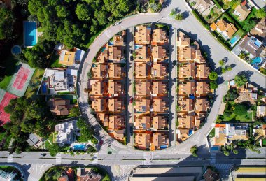 Drone point of view, aerial shot of spanish town of Dehesa de Campoamor during sunny day with high-rise residential buildings, view from above. Spain